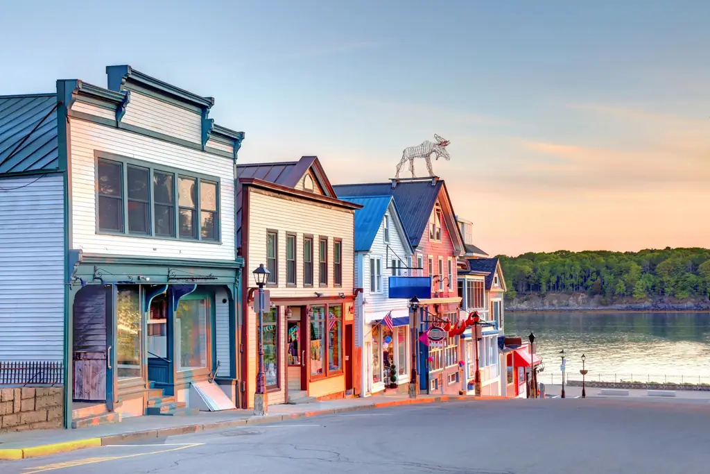 Colorful storefronts on a waterfront street at sunset